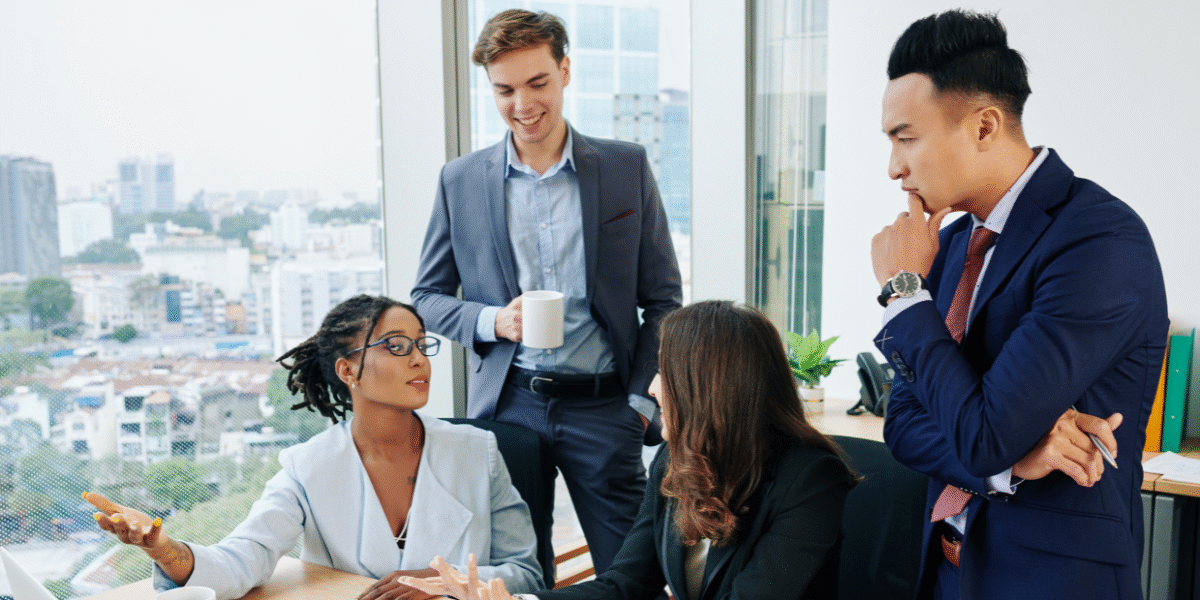 Business team engaged in storytelling session during digital transformation workshop, fostering connection and shared vision.